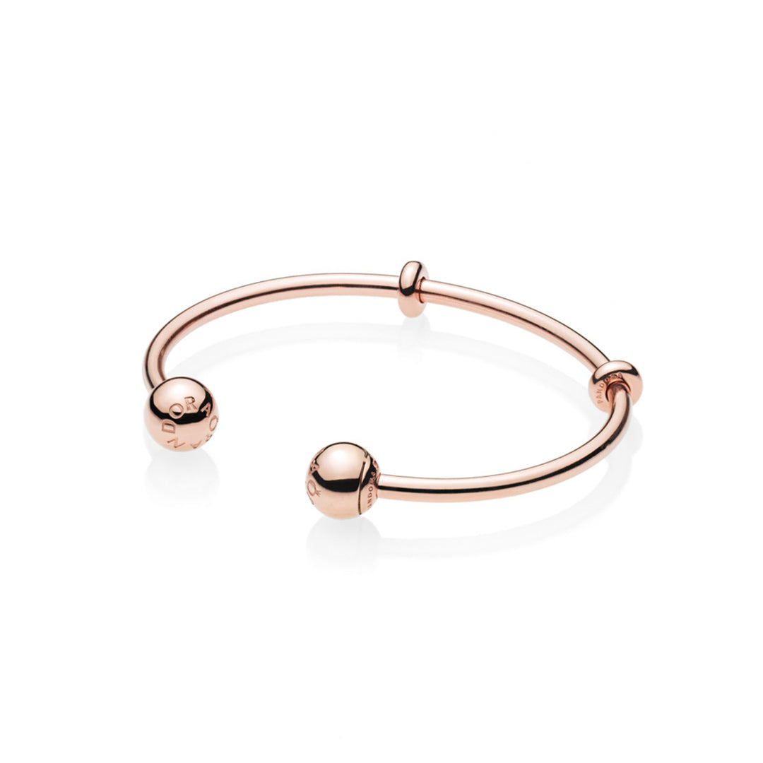 Open bangle in Rose with silicone stoppers and interchangeable end caps